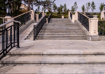 A long wide stone staircase in the park.