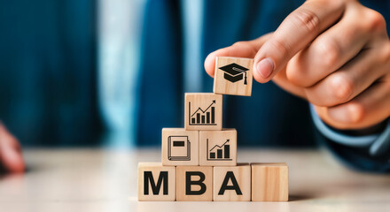 A person is stacking wooden blocks with mba letters and business growth icons, symbolizing career advancement and education