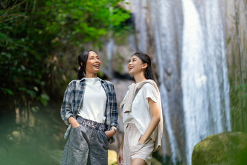 Fototapeta premium Asian Indonesian Women Exploring Grojogan Sewu Waterfall in Yogyakarta Forest