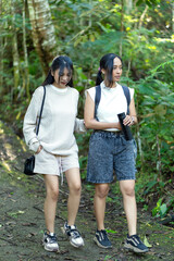 Asian Indonesian Women Hiking Through Lush Jungle Path in Yogyakarta