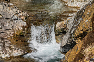 a small waterfall along the road road that goes up the the Stelvio Pass inside the Stelvio National...