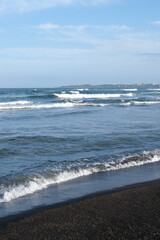 waves on the beach in jeju