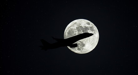 Commercial airplane silhouetted by the moon in a starry night sky