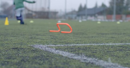 This dynamic video showcases a vibrant soccer training session with athletes running and jumping over hurdles, highlighting youth sports energy