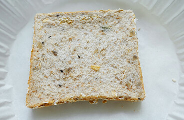 Slice of walnuts whole grains sandwich bread shown as a breakfast snack
