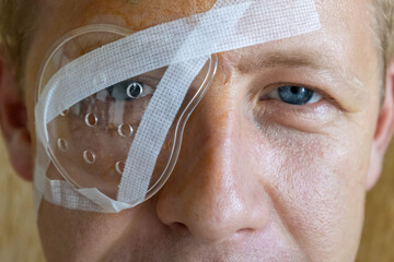 Man recovering from eye surgery at home