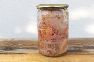 Jar of Traditional Homemade Canned Meat Preserved in Fat on Wooden Table