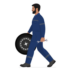 Mechanic walking, holding a tire and a tool