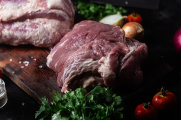 Raw pork neck on a wooden board on the table
