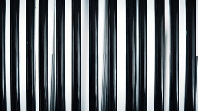 Abstract Metal Vertical Poles in Alternating Dark and Light Pattern With Glossy Finish Creates Modern Industrial