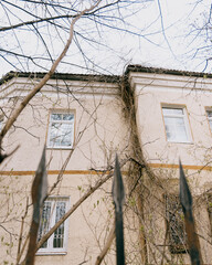 historic house with white and green roofs. The house is surrounded by trees and it has a lot of leaves. turichtiech place, architecture of the old town.