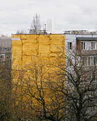 yellow multi-storey house among the trees. the architecture of the old town, residential areas.