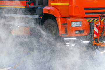 watering truck. The process of washing or cooling the asphalt on the road during extreme heat