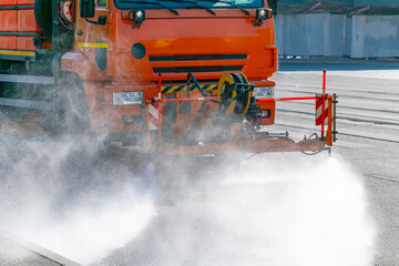 watering truck. The process of washing or cooling the asphalt on the road during extreme heat