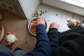 two child's hands cutting vegetables for salad close up