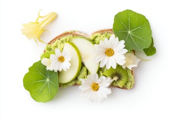 Avocado toast topped with apple slices, kiwi, and edible flowers  