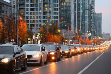 Long line of cars creating traffic congestion on a busy city street during rush hour