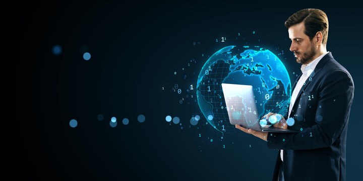 Businessman using laptop with digital world map hologram and binary code on dark background, symbolizing global network and data communication. - Powered by Adobe