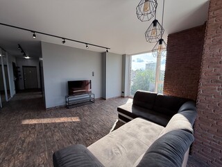Loft-Style Open Space with Brick Walls and Industrial Lighting
