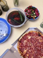 Rustic Outdoor Meal with Pepperoni Pizza and Crayfish