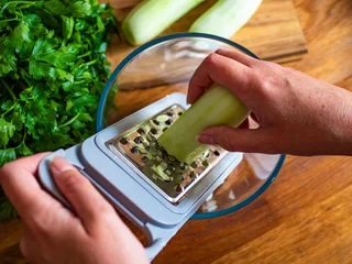  Woman grating fresh cucumber, close-up  © Jacek Chabraszewski