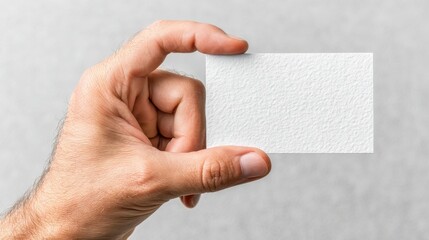 Obraz premium Person Holding Blank White Paper for Creative Business Presentation