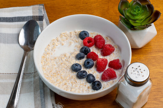 oatmeal top with blue berries and red raspberries