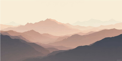 Misty blue mountain peaks at sunrise with sunbeams and clouds in the valley