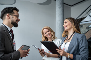 Business people discussing work using digital tablet and clipboard