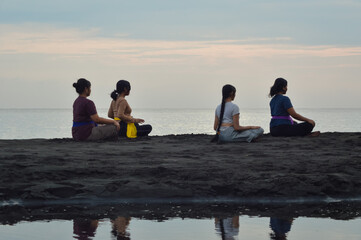 Sitting in silence with closed eyes and relaxed hands on their thighs, the girls immerse in a deep...