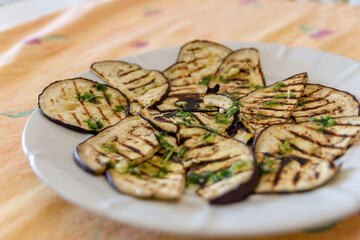 Grilled aubergines seasoned with salt, olive oil and parsley