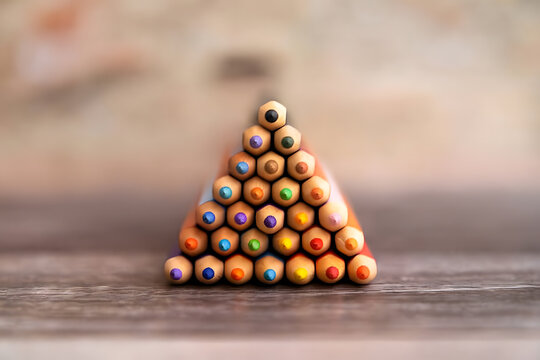 Stacked Colorful Pencils Forming a Pyramid Shape for Artistic and Educational Concept - Powered by Adobe