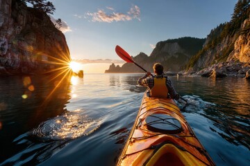 Kayaker paddles on calm water at sunset near rocky coastline