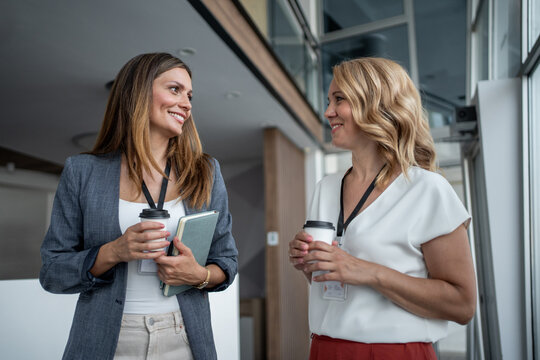 Businesswomen chatting during coffee break at conference