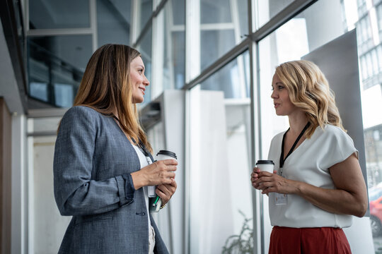 Businesswomen chatting during coffee break at conference
