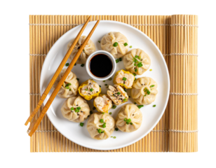 “Steaming Dimsum Platter with Chopsticks on Bamboo Mat, isolated on transparent background”.