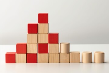 Red and natural colored wooden blocks arranged on white surface, forming increasing and decreasing graph, symbolizing market trends and data analysis