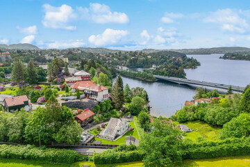 Fototapeta premium beautiful areal view of typical norwegian village from above with luxury villas sea fishermen's houses and boats. fishing village