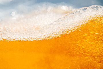 Close up bright orange Oil or beer splash texture and nature waves, Beautiful waves curve and little bubbles smooth for graphic design and background, Oil Bubbles, Soft beer bubbles, Selective focus