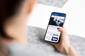News in phone. Press release. Reading digital media. Mockup online newspaper in cellphone screen. Woman using mobile website. Latest article headlines in smartphone.
