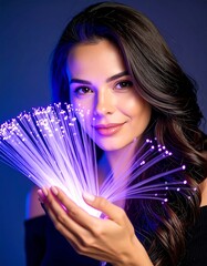 A beautiful woman holding a glowing bundle of purple fiber optic cables, representing digital connection and future technology