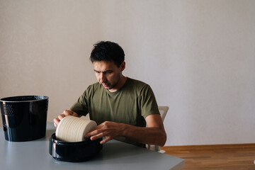Man meticulously cleaning or replacing filter of air humidifier, promoting clean and healthy air in...