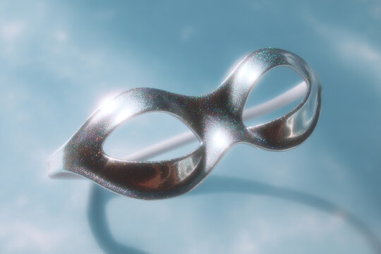 Shimmering silver disguise mask on a serene light blue backdrop, perfect for costume parties, plays, or adding a touch of mystery to any occasion.