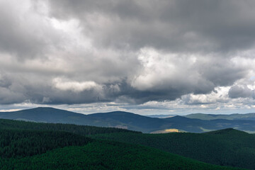 clouds over the mountains hills on layers landscape in summer 