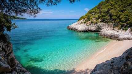 Secluded cove with turquoise water and lush greenery on a sunny day