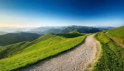 winding path on green hill open sky and distant mountains pathway landscape