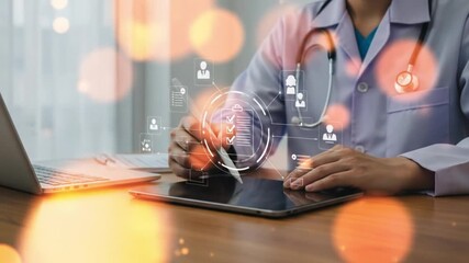 Doctor using tablet with digital medical interface and laptop on desk for healthcare analysis