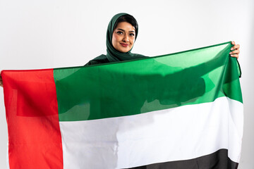 Smiling emirati woman holding united arab emirates flag: celebrating national identity