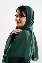 Beautiful muslim woman wearing green hijab posing in studio