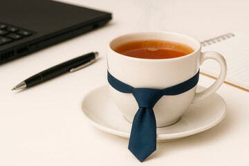 A cup of tea with a tie in the office.